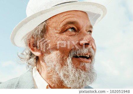 Portrait of a confident, handsome, mature man, pensioner, grandfather in the small town 102051948
