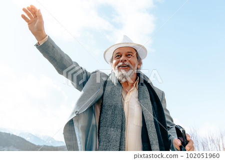 Portrait of a confident, handsome, mature man, pensioner, grandfather in the small town 102051960