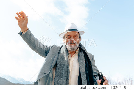 Portrait of a confident, handsome, mature man, pensioner, grandfather in the small town Portrait of a confident, handsome, mature man, pensioner, grandfather in the small town 102051961