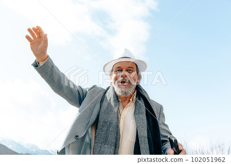 Portrait of a confident, handsome, mature man, pensioner, grandfather in the small town 102051962