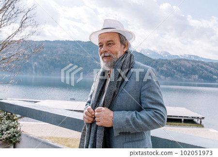 Portrait of a confident, handsome, mature man, pensioner, grandfather in the small town Portrait of a confident, handsome, mature man, pensioner, grandfather in the small town 102051973