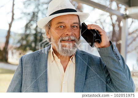Portrait of a confident, handsome, mature man, pensioner, grandfather in the small town Portrait of a confident, handsome, mature man, pensioner, grandfather in the small town 102051975