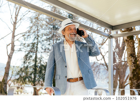 Portrait of a confident, handsome, mature man, pensioner, grandfather in the small town 102051976