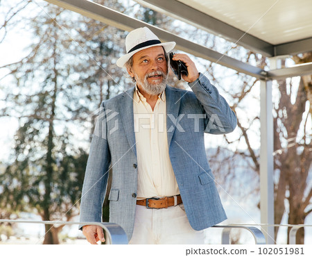 Portrait of a confident, handsome, mature man, pensioner, grandfather in the small town Portrait of a confident, handsome, mature man, pensioner, grandfather in the small town 102051981
