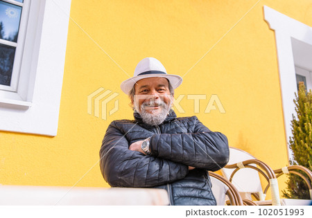 Portrait of a confident, handsome, mature man, pensioner, grandfather in the small town 102051993