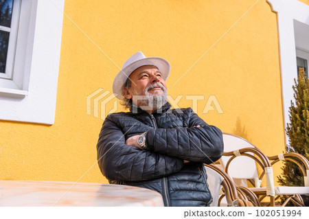 Portrait of a confident, handsome, mature man, pensioner, grandfather in the small town Portrait of a confident, handsome, mature man, pensioner, grandfather in the small town 102051994
