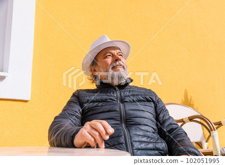 Portrait of a confident, handsome, mature man, pensioner, grandfather in the small town 102051995