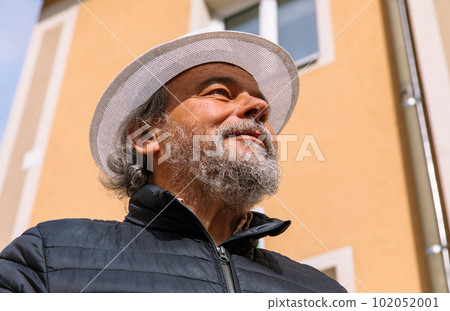 Portrait of a confident, handsome, mature man, pensioner, grandfather in the small town Portrait of a confident, handsome, mature man, pensioner, grandfather in the small town 102052001