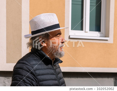 Portrait of a confident, handsome, mature man, pensioner, grandfather in the small town Portrait of a confident, handsome, mature man, pensioner, grandfather in the small town 102052002