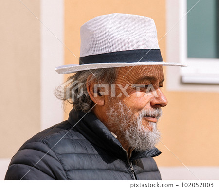 Portrait of a confident, handsome, mature man, pensioner, grandfather in the small town Portrait of a confident, handsome, mature man, pensioner, grandfather in the small town 102052003