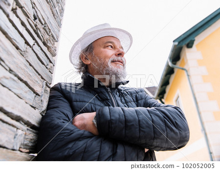 Portrait of a confident, handsome, mature man, pensioner, grandfather in the small town Portrait of a confident, handsome, mature man, pensioner, grandfather in the small town 102052005
