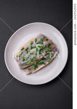 Delicious Atlantic herring marinated with salt and spices Delicious Atlantic herring marinated with salt and spices 102052035