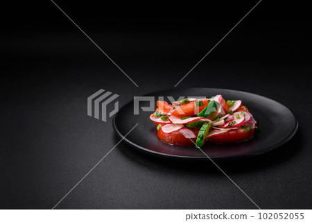 Delicious vegan salad of fresh vegetables of tomatoes, cucumbers and radishes Delicious vegan salad of fresh vegetables of tomatoes, cucumbers and radishes 102052055