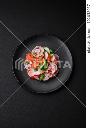 Delicious vegan salad of fresh vegetables of tomatoes, cucumbers and radishes Delicious vegan salad of fresh vegetables of tomatoes, cucumbers and radishes 102052057
