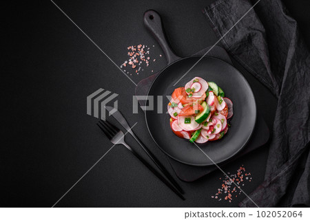 Delicious vegan salad of fresh vegetables of tomatoes, cucumbers and radishes 102052064