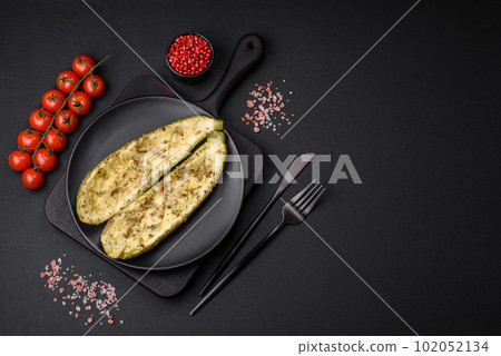 Delicious zucchini cut into two halves baked with salt, spices and herbs 102052134