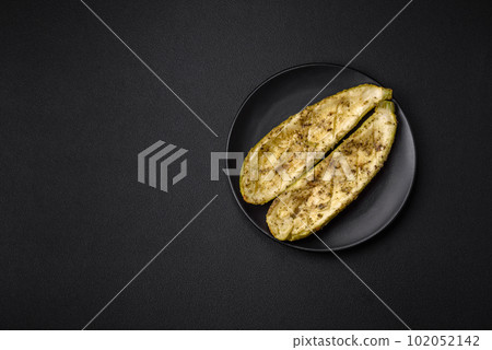 Delicious zucchini cut into two halves baked with salt, spices and herbs Delicious zucchini cut into two halves baked with salt, spices and herbs 102052142