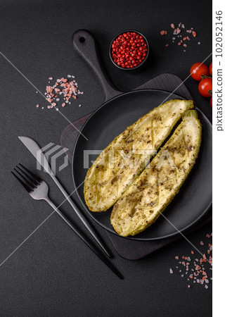 Delicious zucchini cut into two halves baked with salt, spices and herbs 102052146