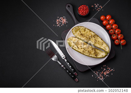 Delicious zucchini cut into two halves baked with salt, spices and herbs Delicious zucchini cut into two halves baked with salt, spices and herbs 102052148