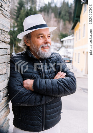 Portrait of a confident, handsome, mature man, pensioner, grandfather in the small town Portrait of a confident, handsome, mature man, pensioner, grandfather in the small town 102052508