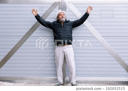 A man standing near his automatic gate, coming home from work, the security and safety of his own home A man standing near his automatic gate, coming home from work, the security and safety of his own home 102052515