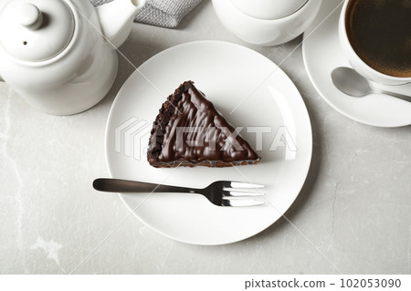 Tasty chocolate cake served on grey marble table, flat lay Tasty chocolate cake served on grey marble table, flat lay 102053090