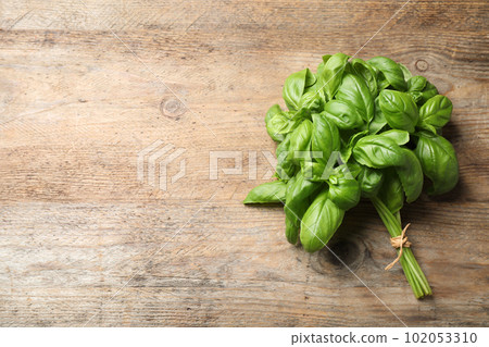 Fresh basil on wooden table, top view. Space for text Fresh basil on wooden table, top view. Space for text 102053310