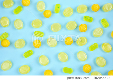 Delicious lemon candies on light blue background, flat lay 102053428