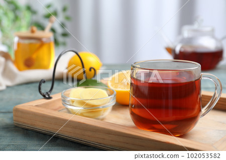 Delicious tea with honey, ginger and lemon on tray 102053582