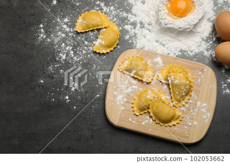 Flat lay composition with raw ravioli on grey table. Italian pasta Flat lay composition with raw ravioli on grey table. Italian pasta 102053662