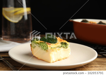 Tasty broccoli casserole served on wooden table Tasty broccoli casserole served on wooden table 102053791