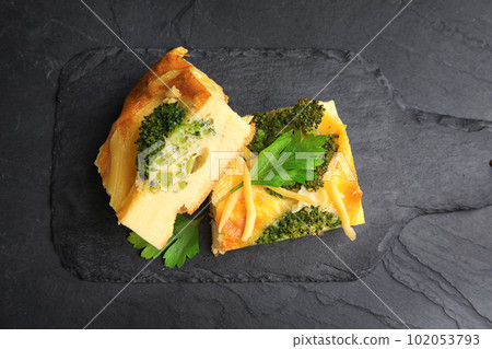 Tasty broccoli casserole served on black table, top view 102053793