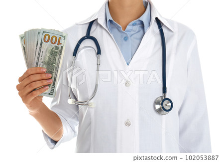 Doctor with bribe on white background, closeup. Corruption in medicine 102053887