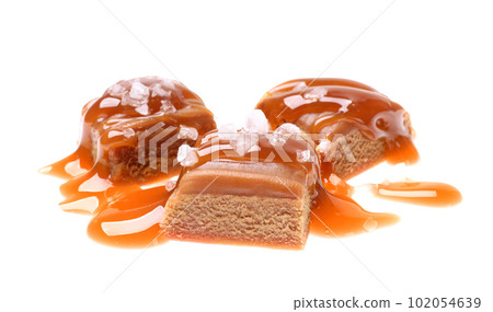 Delicious salted caramel with sauce on white background 102054639