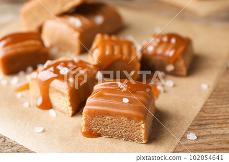 Salted caramel on wooden table, closeup view 102054641