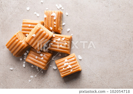 Salted caramel on light grey table, flat lay. Space for text Salted caramel on light grey table, flat lay. Space for text 102054718