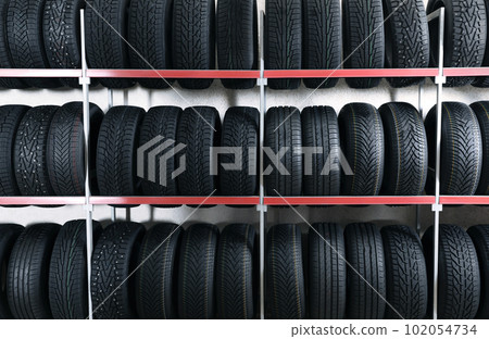 Car tires on rack in auto store Car tires on rack in auto store 102054734
