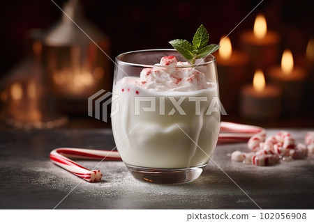 A chilly, peppermint-infused cocktail, featuring a creamy, white chocolate liqueur-based drink, served in a frosty glass with a candy cane set against a snowy, holiday-inspired backdrop. Generative Ai 102056908