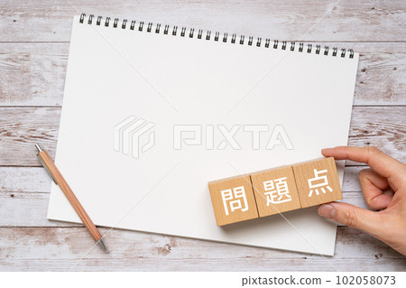 Problems and written blocks, notebooks, pens, hands 102058073
