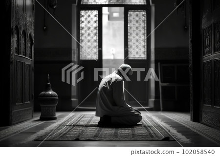 A man praying at a mosque. Man s devotion as he prays. The mosque be shown in the background to emphasis on the spiritual aspect of Ramadan. Generative AI. 102058540