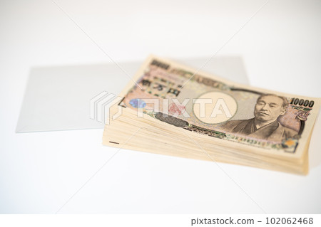 take out a wad of money from an envelope take out a wad of money from an envelope 102062468
