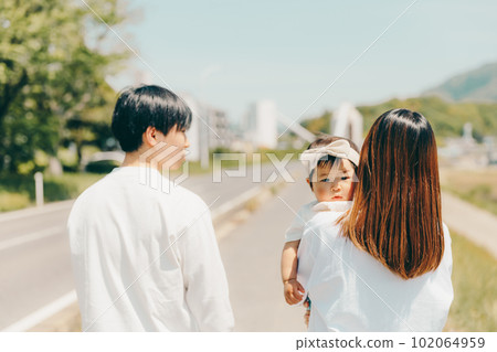 Family walk along the bank 102064959