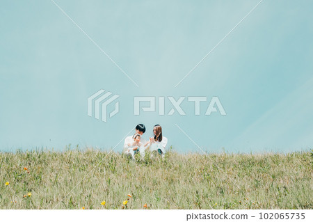 family sitting on the bank 102065735