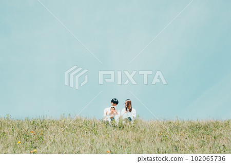 family sitting on the bank 102065736