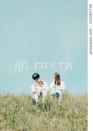 family sitting on the bank 102065739