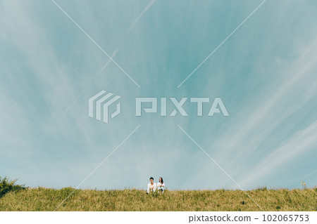 family sitting on the bank 102065753
