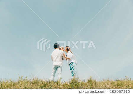 family standing along the bank family standing along the bank 102067310