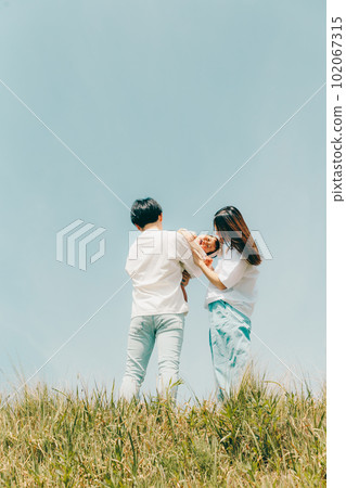 family standing along the bank 102067315