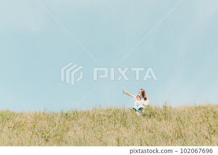 family sitting on the bank 102067696
