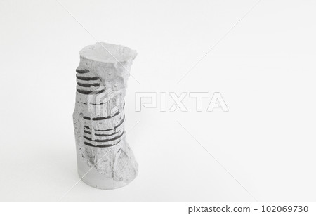 The sculptural shape of the test piece left after the reinforced concrete compressive strength test The sculptural shape of the test piece left after the reinforced concrete compressive strength test 102069730